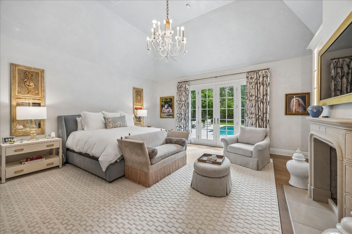 620 Hedwig Road Hunters Creek Village, TX 77024 - Photo 18 of 47 A tranquil primary retreat with vaulted ceiling, fireplace, and sitting area, opening through French doors to serene poolside views.