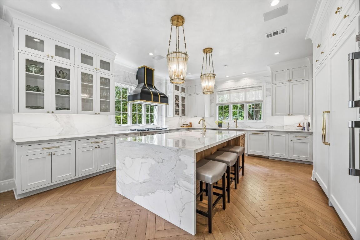 620 Hedwig Road Hunters Creek Village, TX 77024 - Photo 4 of 47 A showstopping kitchen anchored by a waterfall marble island, with Thermador appliances, a custom statement hood, and designer lighting.