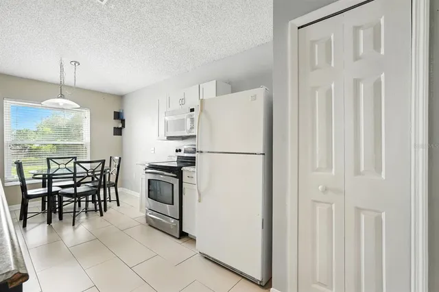 a kitchen with a stove a sink a microwave and dining table