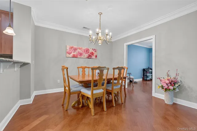 a view of a dining room with furniture wooden floor and a chandelier