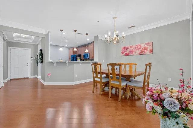 a view of a dining room with furniture and chandelier