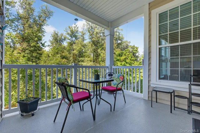 a view of a two chairs in the balcony