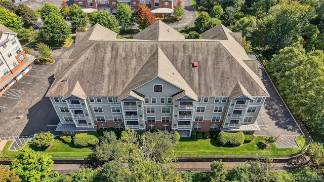 an aerial view of a house with a yard