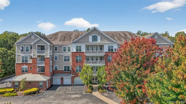 a front view of a house with a garden and plants