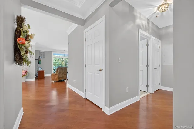 a view of a livingroom with wooden floor and a chandelier