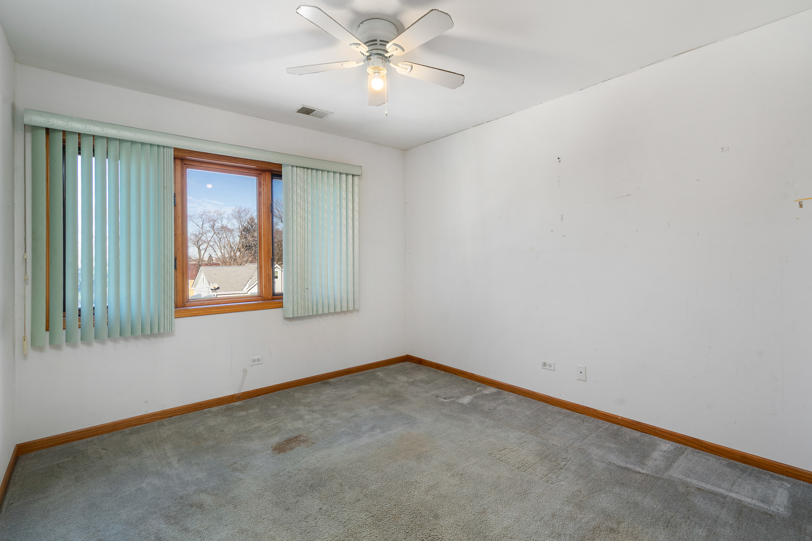 5242 West 79th Street, Unit 3D Burbank, IL 60459 - Photo 15 of 26 an empty room with a window and a fan