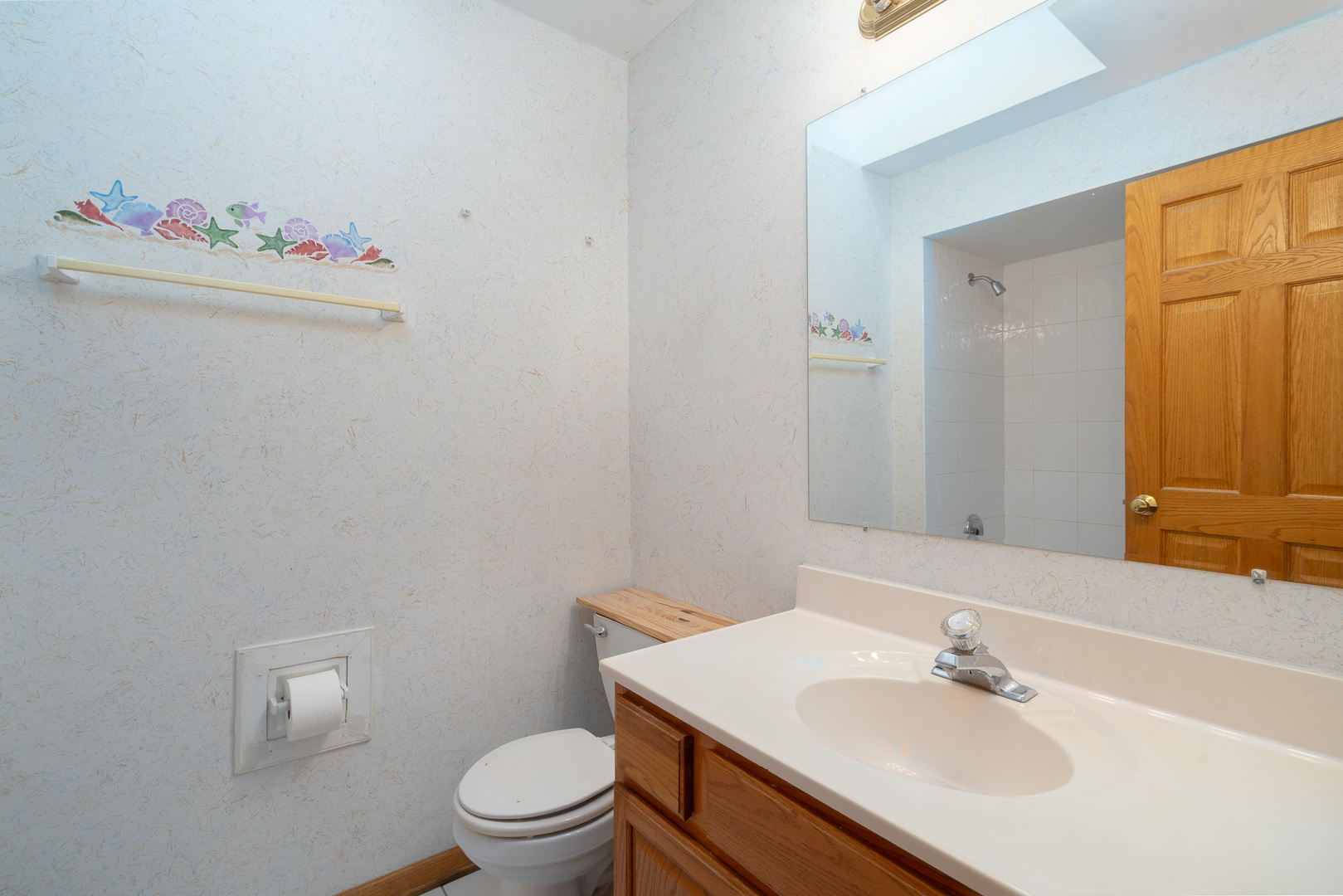 5242 West 79th Street, Unit 3D Burbank, IL 60459 - Photo 16 of 26 a bathroom with a sink toilet and a mirror