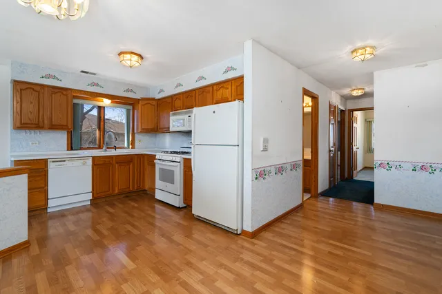 a kitchen with refrigerator and cabinets