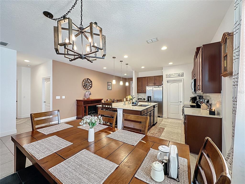 3193 Crispin Circle Harmony, FL 34773 - Photo 11 of 64 a living room with stainless steel appliances kitchen island granite countertop furniture and a view of kitchen