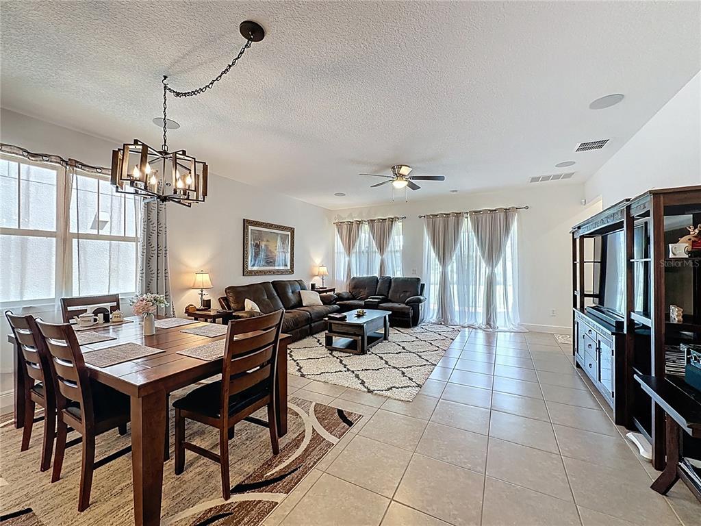 3193 Crispin Circle Harmony, FL 34773 - Photo 15 of 64 a very nice looking dining room with a large glass table and chairs