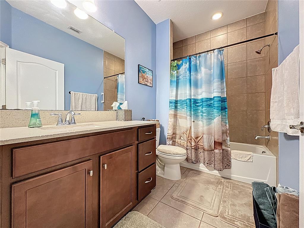 3193 Crispin Circle Harmony, FL 34773 - Photo 16 of 64 a spacious bathroom with a double vanity sink toilet and shower