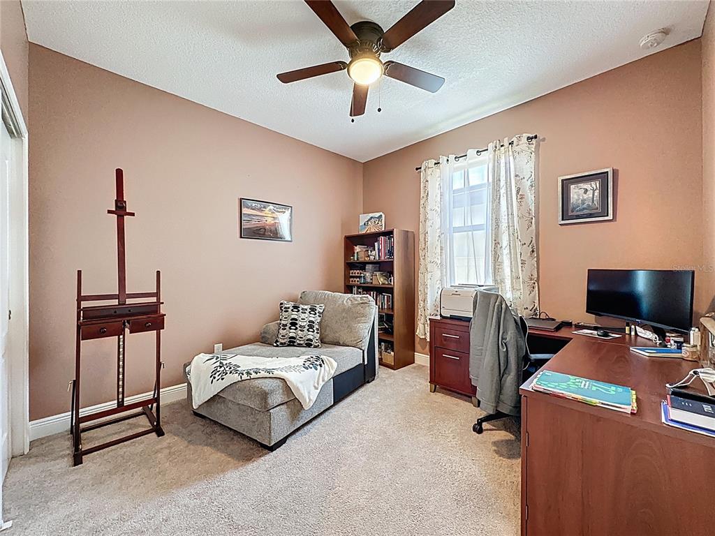 3193 Crispin Circle Harmony, FL 34773 - Photo 18 of 64 a bedroom with a bed and a flat screen tv