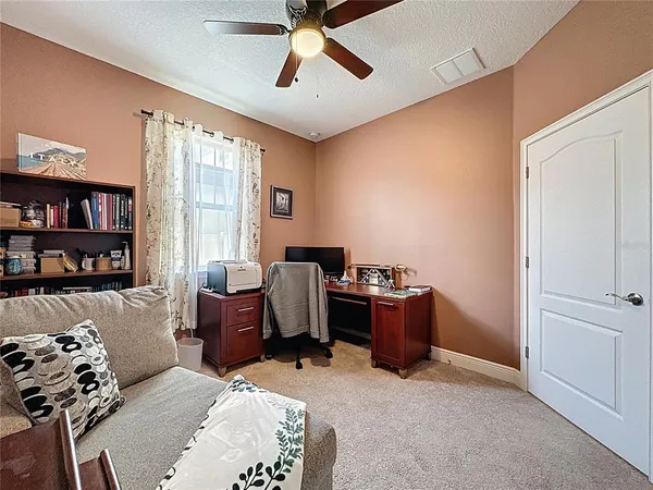 a room with a bed and a chandelier