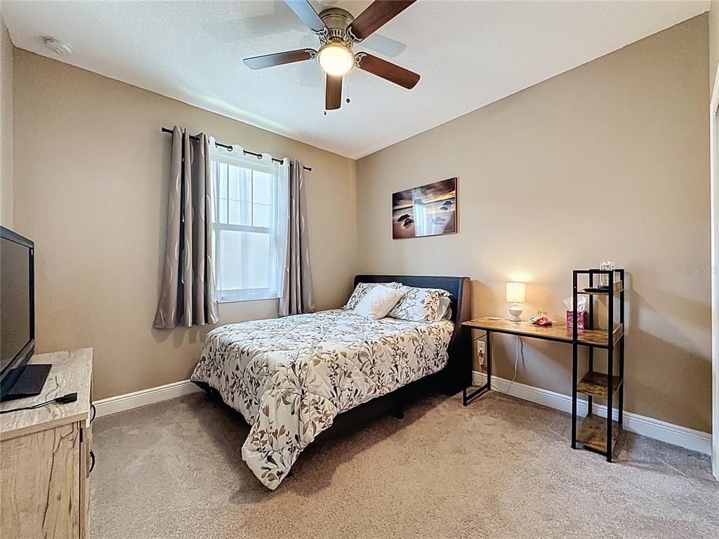 3193 Crispin Circle Harmony, FL 34773 - Photo 20 of 64 a room with a bed and a chandelier