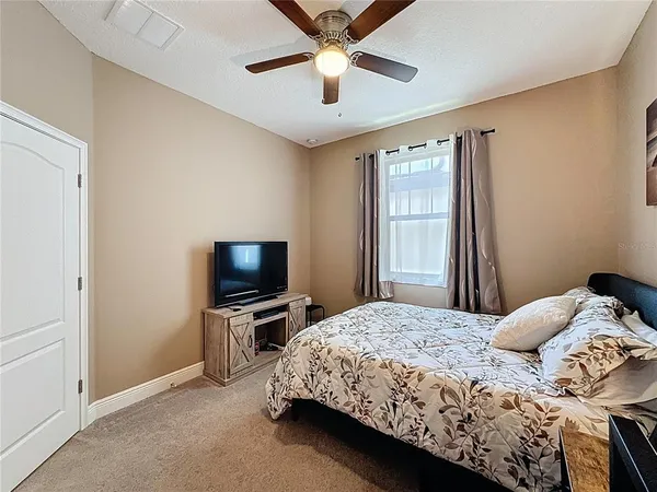 a bedroom with a bed and a chandelier