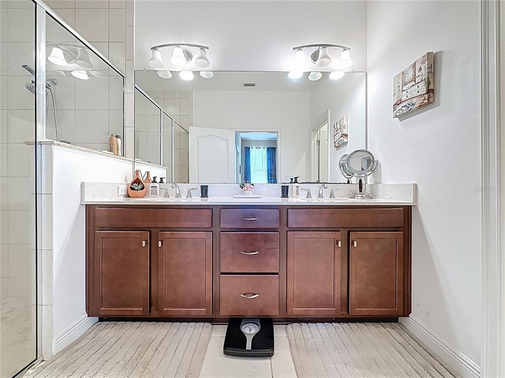 3193 Crispin Circle Harmony, FL 34773 - Photo 30 of 64 a bathroom with a sink double vanity and a mirror