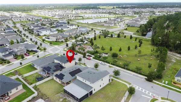 an aerial view of residential houses with outdoor space