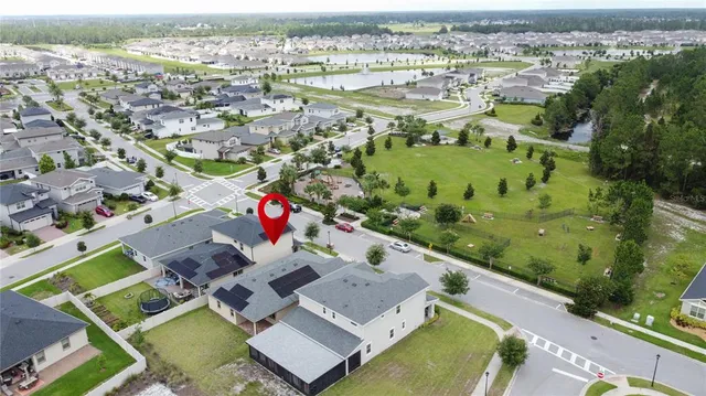 an aerial view of residential houses with outdoor space