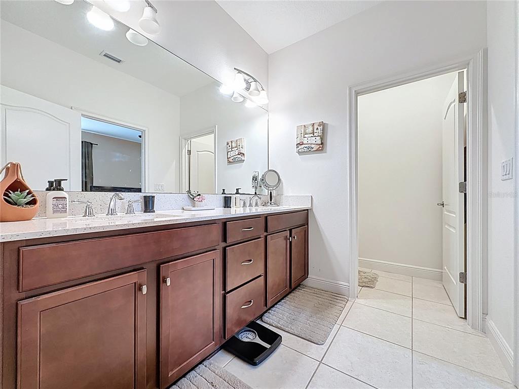 3193 Crispin Circle Harmony, FL 34773 - Photo 31 of 64 a spacious bathroom with a double vanity sink mirror and