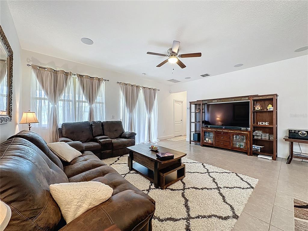 3193 Crispin Circle Harmony, FL 34773 - Photo 37 of 64 a living room with furniture and a flat screen tv