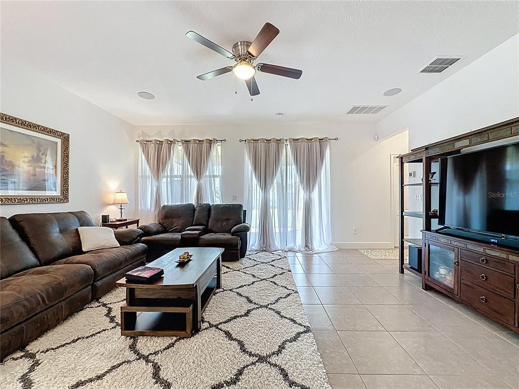 3193 Crispin Circle Harmony, FL 34773 - Photo 38 of 64 a living room with furniture and a flat screen tv