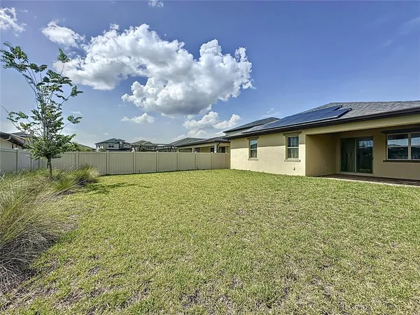 an aerial view of a house having swimming pool having outdoor seating