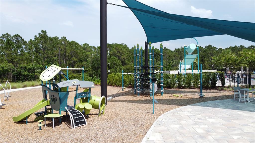 3193 Crispin Circle Harmony, FL 34773 - Photo 64 of 64 a view of a patio with a table chairs and a backyard