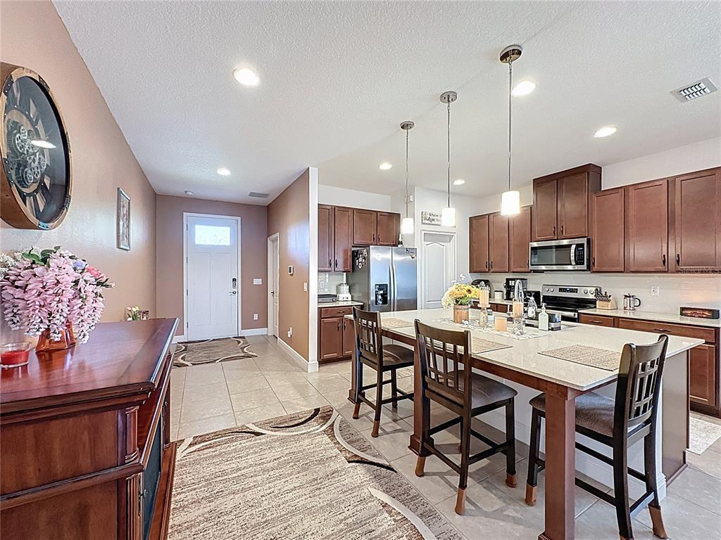 3193 Crispin Circle Harmony, FL 34773 - Photo 8 of 64 a view of a dining room and livingroom with furniture wooden floor a chandelier