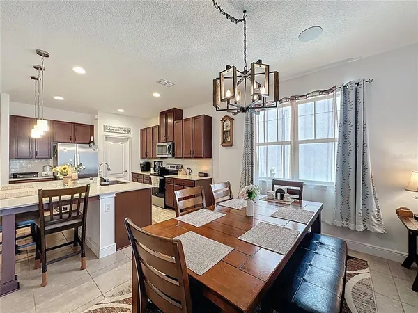 a living room with stainless steel appliances kitchen island granite countertop furniture and a view of kitchen