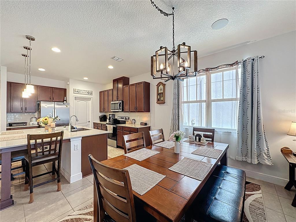 3193 Crispin Circle Harmony, FL 34773 - Photo 10 of 64 a view of a dining room and livingroom with furniture wooden floor a chandelier