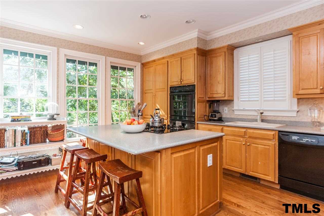 3201 Millstream Place Raleigh, NC 27609 - Photo 11 of 16 a kitchen with stainless steel appliances granite countertop a stove a sink dishwasher and a refrigerator