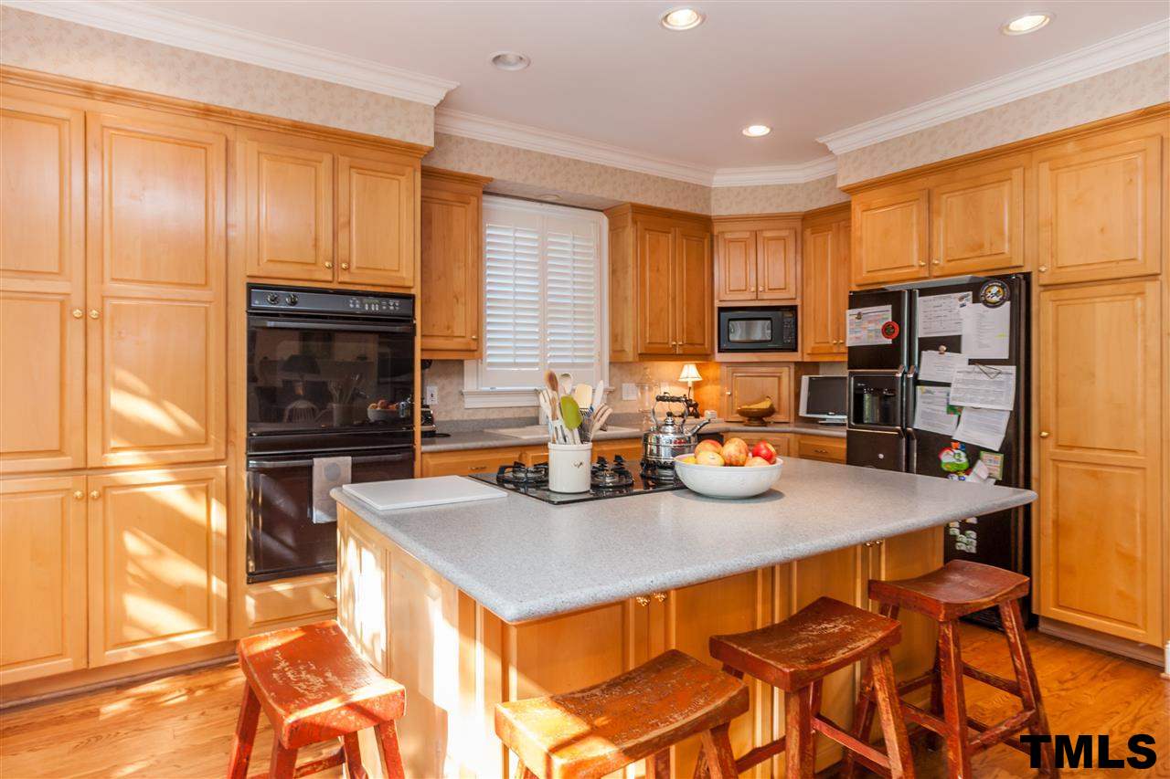 3201 Millstream Place Raleigh, NC 27609 - Photo 12 of 16 a kitchen with a table chairs and refrigerator