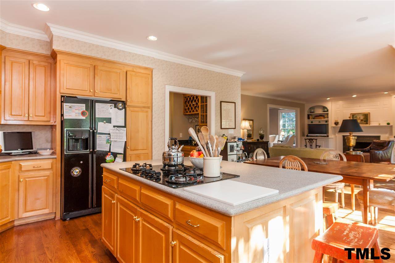 3201 Millstream Place Raleigh, NC 27609 - Photo 13 of 16 a view of a kitchen with kitchen island granite countertop a large counter top stainless steel appliances and cabinets