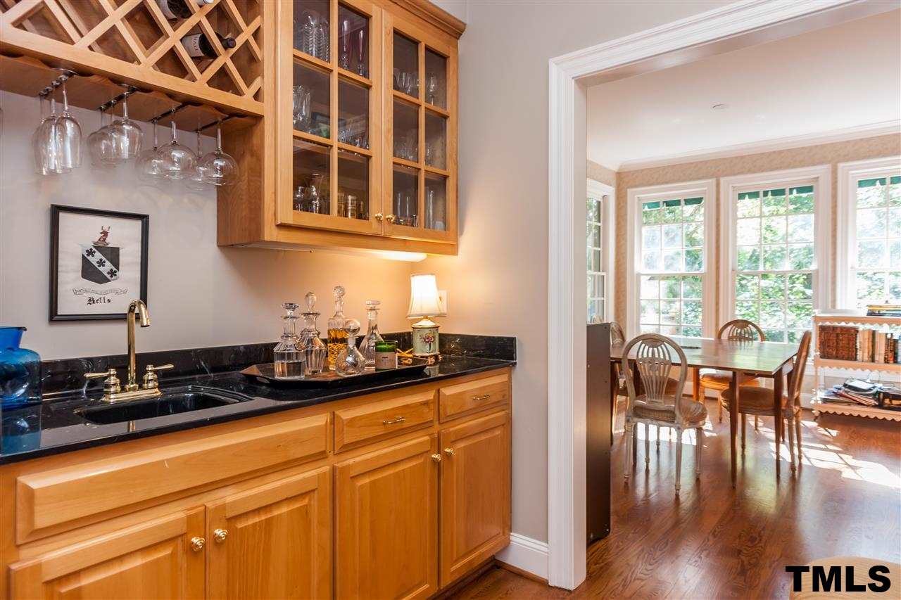 3201 Millstream Place Raleigh, NC 27609 - Photo 14 of 16 a kitchen with granite countertop a stove and cabinets
