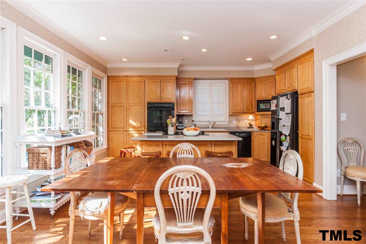 3201 Millstream Place Raleigh, NC 27609 - Photo 10 of 16 a dining table & kitchen with a large window