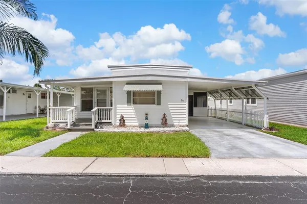 a view of a house with a yard and a garden
