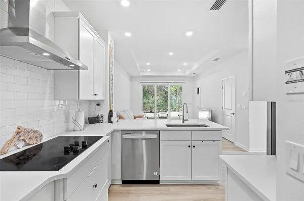 a kitchen with a sink a stove a refrigerator and cabinets