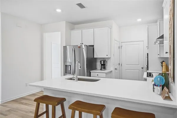 a bathroom with a sink and a large mirror