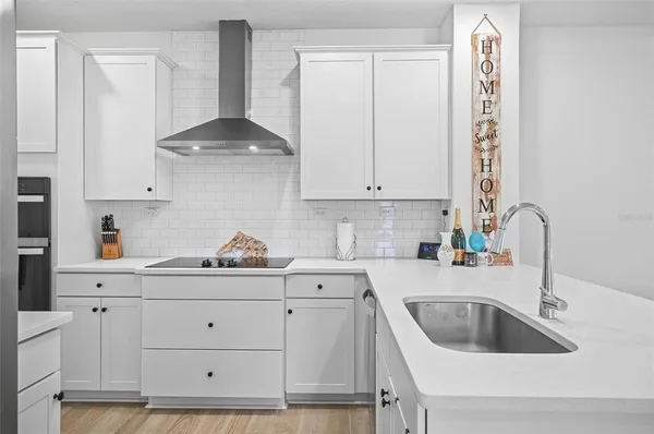 a kitchen with a sink cabinets and window