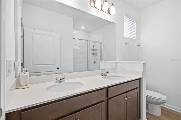 a bathroom with a sink double vanity and a toilet