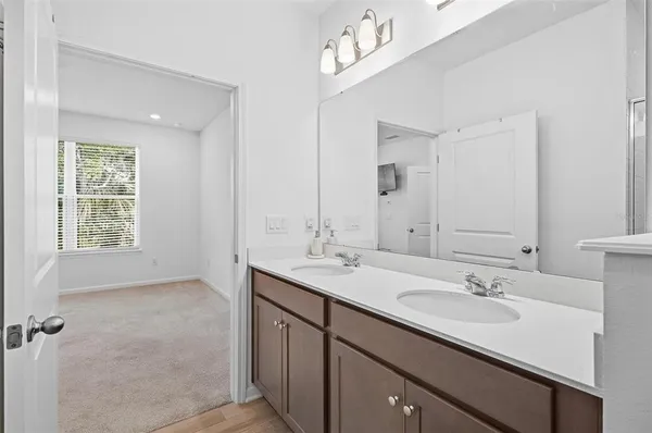 a bathroom with a sink double vanity and a mirror