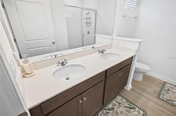 a bathroom with a double vanity sink and a mirror