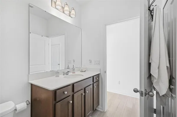 a bathroom with a sink a toilet and a mirror