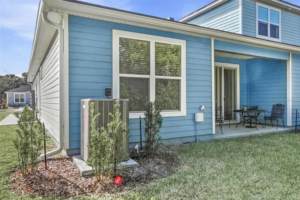 a front view of a house with outdoor seating