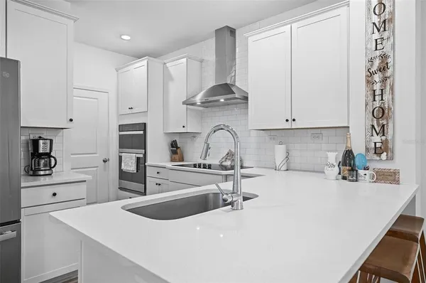a kitchen with a sink a stove and cabinets