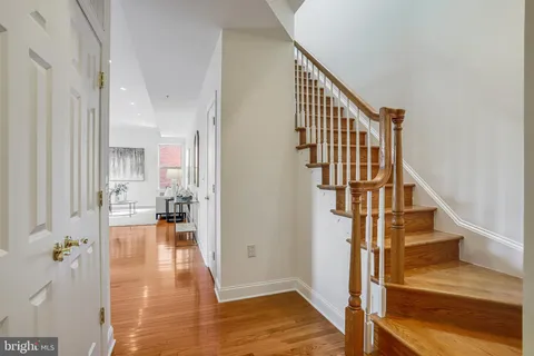 a view of entryway and hall with wooden floor