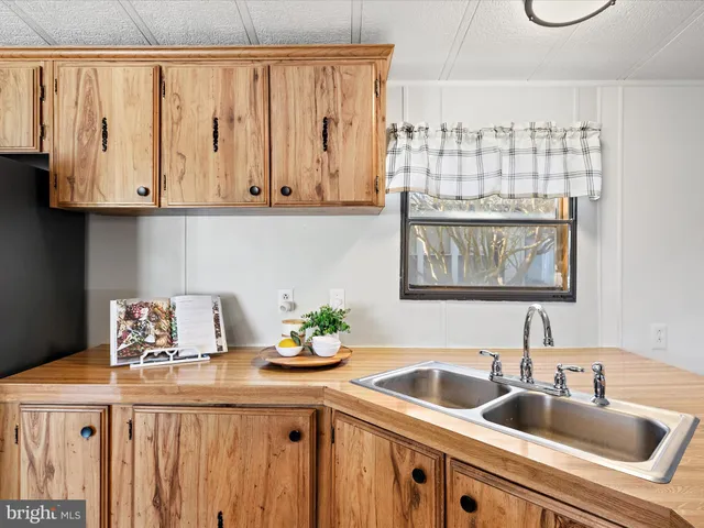 a kitchen with stainless steel appliances granite countertop a sink and a white cabinets