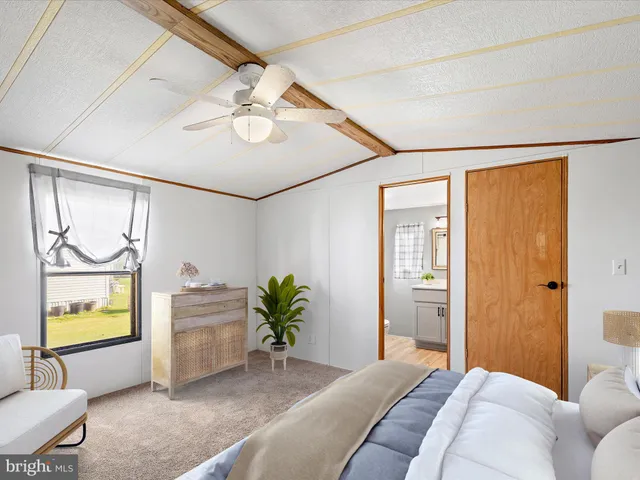 a bedroom with a bed and ceiling fan