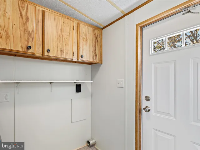 a kitchen with a white cabinets and a refrigerator