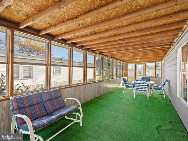 a sitting area with furniture and wooden fence